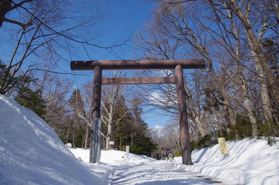 Snow-covered torii gate at a Japanese shrine in winter