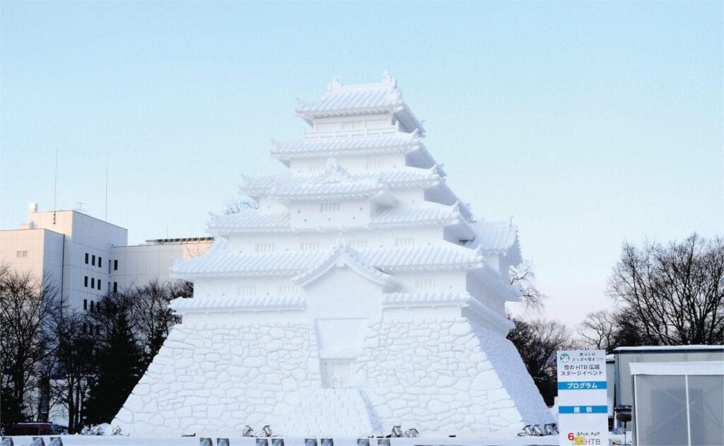 Daytime panoramic snow castle sculpture at Sapporo Snow Festival