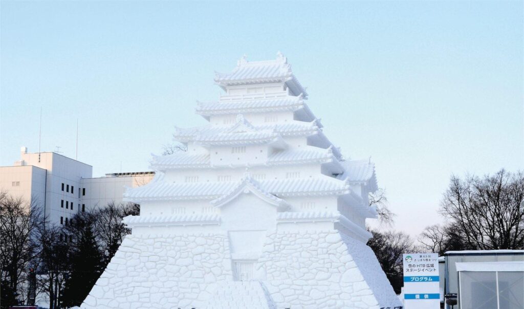 Daytime panoramic snow castle sculpture at Sapporo Snow Festival
