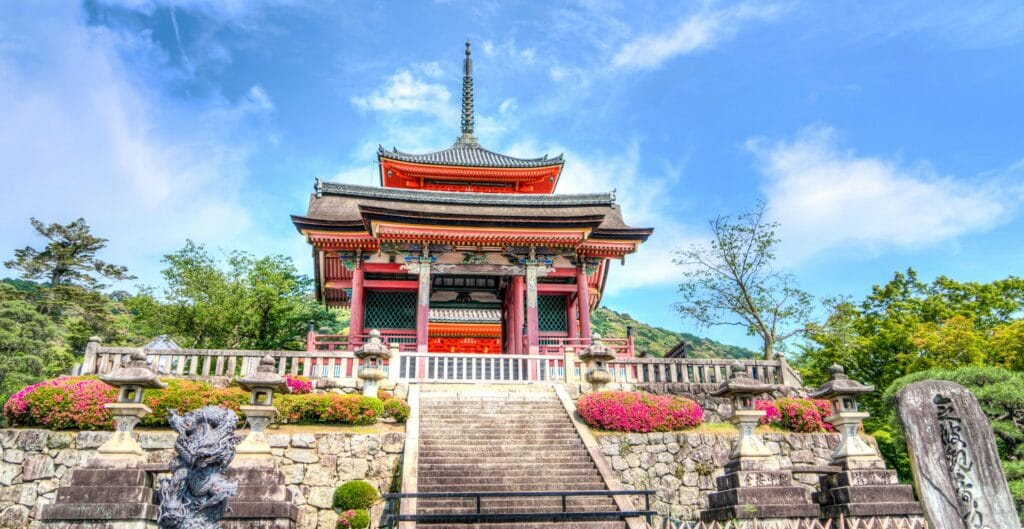 Stunning view of a traditional Japanese temple surrounded by lush gardens in Kyoto.