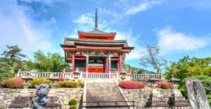 Stunning view of a traditional Japanese temple surrounded by lush gardens in Kyoto.