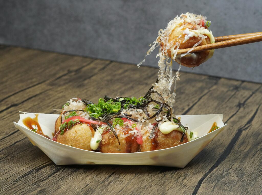 Close-up of takoyaki, a popular Japanese street food, served in Nha Trang, Vietnam.