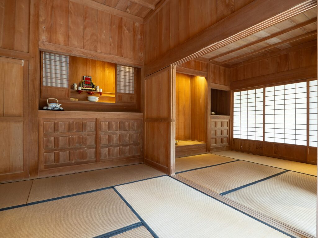 Where to Stay in Okinawa: Best Areas for Couples, Families & Budget Travelers Interior of a wooden tatami room with shoji screens in Okinawa, Japan.